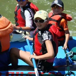 a group of people sitting on a raft