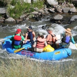 a little girl riding on a raft in a body of water