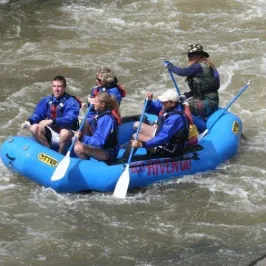 a man riding on a raft in a body of water