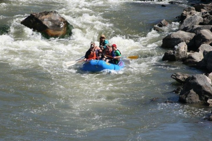 a man and a woman riding a wave on a surfboard in the water
