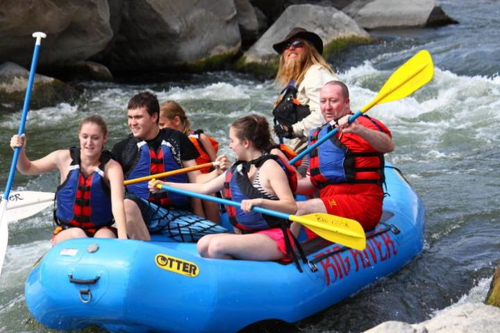 a group of people on a raft in a body of water