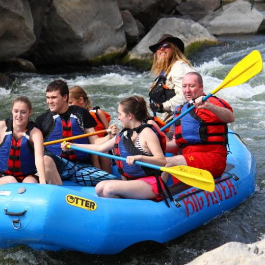 a group of people on a raft in a body of water
