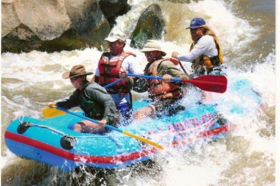 a group of people riding on a raft in a body of water