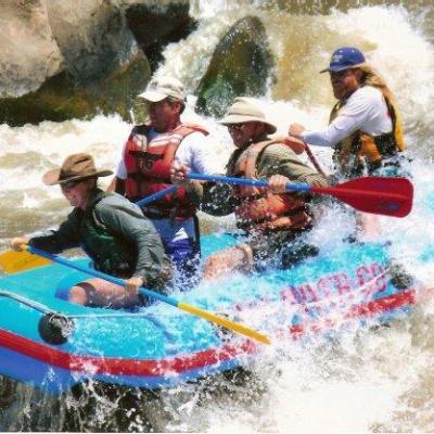 a group of people riding on a raft in a body of water