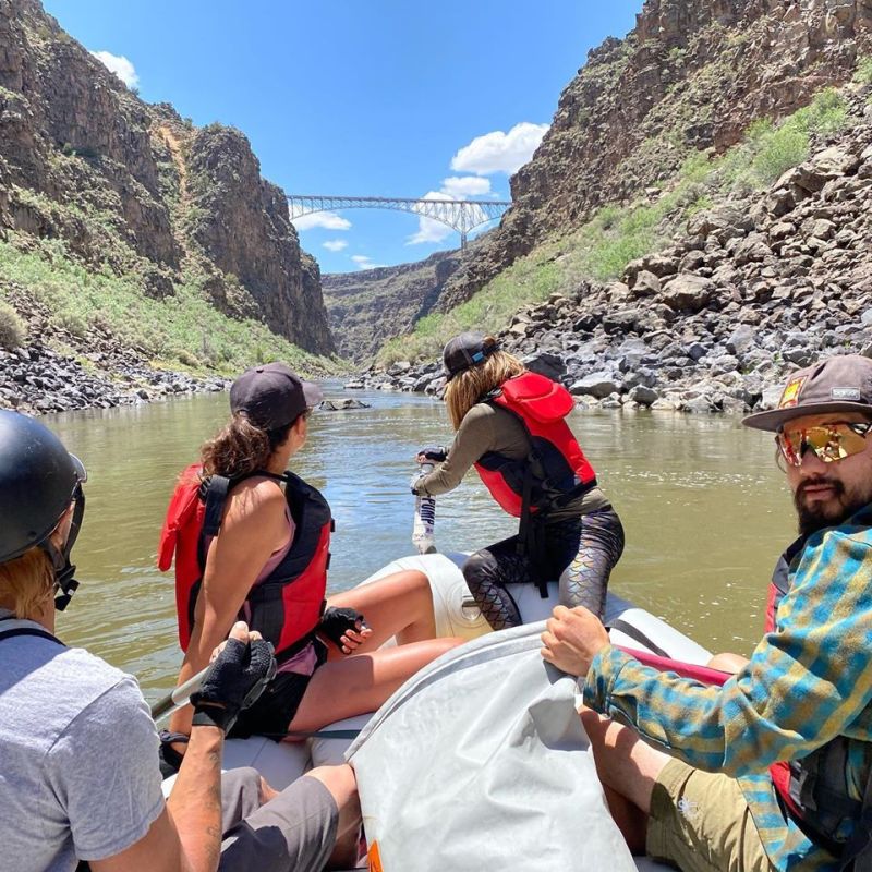 a group of people sitting on the side of a mountain
