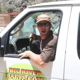 a man wearing sunglasses driving a car