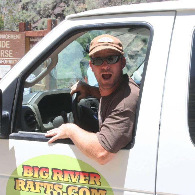 a man wearing sunglasses driving a car